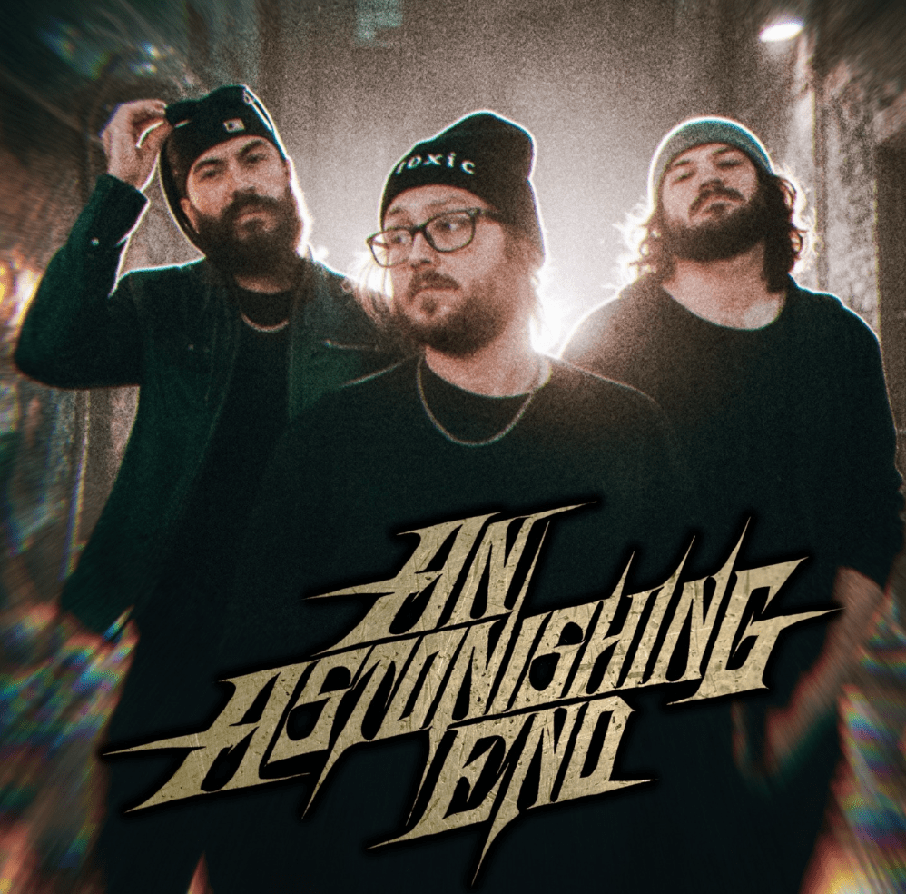 Three musicians posing together in a dimly lit urban setting, wearing casual clothing and beanies, with the text 'AN ASTONISHING END' prominently displayed.